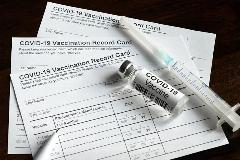 Vaccination card with vaccine and syringe